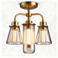 Bronze three-light chandelier with clear glass shades and industrial design